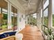 Relaxing screened porch with wood floors, ceiling fans, and views of the surrounding greenery at 735 Davidson Run Ln, Davidson, NC 28036