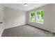 Well-lit bedroom featuring neutral carpeting and large windows at 737 Lynville Ln, Rock Hill, SC 29730