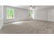 Inviting carpeted bedroom with ample natural light from two windows and ceiling fan at 737 Lynville Ln, Rock Hill, SC 29730
