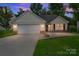 Charming one-story home featuring a one car garage and stone accents at dusk at 737 Lynville Ln, Rock Hill, SC 29730