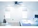 Bright bedroom with two windows, ceiling fan, and stylish decor at 7708 Harrington Woods Rd, Charlotte, NC 28269