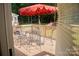 Outdoor dining set and red patio umbrella create an inviting deck space at 7708 Harrington Woods Rd, Charlotte, NC 28269