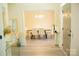 View of dining room with hardwood floors, a modern chandelier, a table, and six chairs at 7708 Harrington Woods Rd, Charlotte, NC 28269