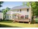 Two-story home features a large deck and a well-maintained yard at 7708 Harrington Woods Rd, Charlotte, NC 28269