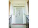 Close up of front door featuring a gray door, sidelights, and black hardware at 7708 Harrington Woods Rd, Charlotte, NC 28269