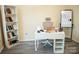 Bright home office with neutral walls, laminate floors, a modern desk, and white shelving at 7708 Harrington Woods Rd, Charlotte, NC 28269