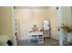 Well-lit home office with neutral decor, desk, shelving and laminate floors at 7708 Harrington Woods Rd, Charlotte, NC 28269