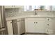 This kitchen features stainless steel appliances, white cabinets, and a subway tile backsplash at 7708 Harrington Woods Rd, Charlotte, NC 28269