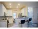 Open kitchen with white cabinetry, breakfast bar, and stainless steel appliances at 7708 Harrington Woods Rd, Charlotte, NC 28269