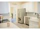 Updated kitchen with stainless steel refrigerator and modern countertops offers open dining area at 7708 Harrington Woods Rd, Charlotte, NC 28269