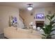 Inviting living room featuring a brick fireplace, neutral colors, and staircase access at 7708 Harrington Woods Rd, Charlotte, NC 28269
