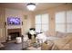 Cozy living room with fireplace, large couch, and natural lighting at 7708 Harrington Woods Rd, Charlotte, NC 28269