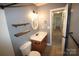 Bathroom features a toilet, vanity with sink, a mirror, floating shelves, and tile flooring at 7830 Shiny Meadow Ln, Charlotte, NC 28215