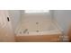 Bathroom featuring a garden tub at 7830 Shiny Meadow Ln, Charlotte, NC 28215