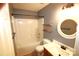 Bathroom features a tub-shower, toilet, vanity with sink, a mirror, and floating shelves for additional storage at 7830 Shiny Meadow Ln, Charlotte, NC 28215