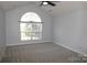 Bedroom featuring neutral color scheme and a large window at 7830 Shiny Meadow Ln, Charlotte, NC 28215