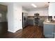 Modern kitchen with white and gray cabinets, stainless steel appliances and hardwood floors at 7830 Shiny Meadow Ln, Charlotte, NC 28215