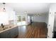 Open-concept living room featuring hardwood floors, natural light, and access to the backyard at 7830 Shiny Meadow Ln, Charlotte, NC 28215