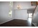 Inviting living room featuring high ceilings, staircase and beautiful hardwood floors at 7830 Shiny Meadow Ln, Charlotte, NC 28215