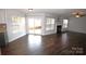 Spacious living room featuring a fireplace, hardwood floors, and a sliding door to the backyard at 7830 Shiny Meadow Ln, Charlotte, NC 28215