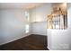 Bright living room featuring high ceilings, hardwood floors, staircase, and natural light at 7830 Shiny Meadow Ln, Charlotte, NC 28215
