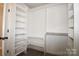 Spacious walk-in closet features built-in shelving units and ample hanging space, maximizing storage and organization at 7830 Shiny Meadow Ln, Charlotte, NC 28215
