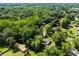 Aerial view of a home surrounded by lush greenery in a peaceful, wooded neighborhood at 7921 Willhill Rd, Mint Hill, NC 28227