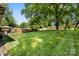 A view of a large back yard with a gazebo, shed, privacy fence, and mature trees at 7921 Willhill Rd, Mint Hill, NC 28227