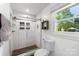 Bathroom with sleek white subway tile shower and a glass door enclosure at 7921 Willhill Rd, Mint Hill, NC 28227