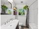 Clean, bright bathroom featuring a modern vanity, white subway tile, and a shower-tub combo with stylish fixtures at 7921 Willhill Rd, Mint Hill, NC 28227