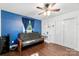 Bedroom featuring hardwood floors and a blue accent wall with constellations at 7921 Willhill Rd, Mint Hill, NC 28227