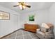 Bright bedroom featuring white walls, hardwood floors, and a cozy armchair at 7921 Willhill Rd, Mint Hill, NC 28227