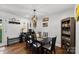 Stylish dining room featuring a modern chandelier, hardwood floors, and a dark dining set for Gathering gatherings at 7921 Willhill Rd, Mint Hill, NC 28227