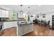 Bright kitchen featuring white cabinetry, modern appliances, and a center island that opens into the dining area at 7921 Willhill Rd, Mint Hill, NC 28227