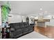 Spacious living room showcasing hardwood floors, modern decor, and seamless flow to the adjacent kitchen area at 7921 Willhill Rd, Mint Hill, NC 28227