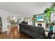 Inviting living room featuring a cozy fireplace, hardwood floors, and seamlessly flows into the kitchen and dining area at 7921 Willhill Rd, Mint Hill, NC 28227