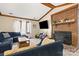 Inviting living room with a brick fireplace, beamed ceiling, and comfortable seating at 8007 Red Lantern Rd, Indian Trail, NC 28079