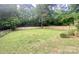 Large backyard with partial fencing and ample green space at 8742 Rittenhouse Cir, Charlotte, NC 28270