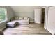 Bedroom featuring a light grey sofa, gray hardwood floors, and a window at 8742 Rittenhouse Cir, Charlotte, NC 28270