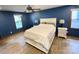 The main bedroom features hardwood floors, a ceiling fan, and ample natural light at 8742 Rittenhouse Cir, Charlotte, NC 28270