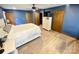 The main bedroom features hardwood floors, a ceiling fan, a dresser, and three closets at 8742 Rittenhouse Cir, Charlotte, NC 28270
