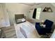 Cute bedroom featuring a crib, a blue chair and patterned floor rug at 8742 Rittenhouse Cir, Charlotte, NC 28270