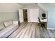 Comfortable bedroom with modern computer desk and chair plus door and closet at 8742 Rittenhouse Cir, Charlotte, NC 28270