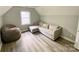 Cozy bedroom featuring a comfortable couch, soft beanbag chair, and light hardwood floors at 8742 Rittenhouse Cir, Charlotte, NC 28270