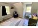 Comfortable bedroom with two windows, a blue chair, and patterned floor rug at 8742 Rittenhouse Cir, Charlotte, NC 28270