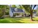 Charming home featuring light blue siding, a welcoming porch with a yellow door, and a well-maintained front yard at 8742 Rittenhouse Cir, Charlotte, NC 28270