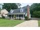 Charming exterior of home featuring a welcoming front porch, well-manicured lawn, and classic architectural details at 8742 Rittenhouse Cir, Charlotte, NC 28270