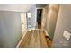 Hallway with light wood floors and white shelving units at 8742 Rittenhouse Cir, Charlotte, NC 28270