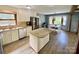 Well-lit kitchen with white cabinets, stainless steel appliances, a central island, and a dining area at 8742 Rittenhouse Cir, Charlotte, NC 28270
