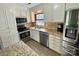 Modern kitchen featuring stainless steel appliances, granite countertops, and light tile backsplash at 8742 Rittenhouse Cir, Charlotte, NC 28270